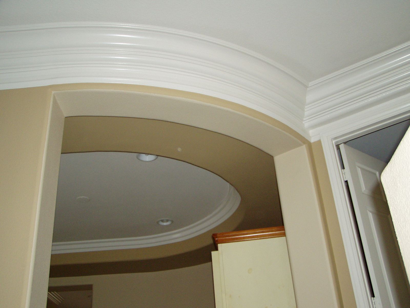 Flexible crown molding around an oval ceiling opening